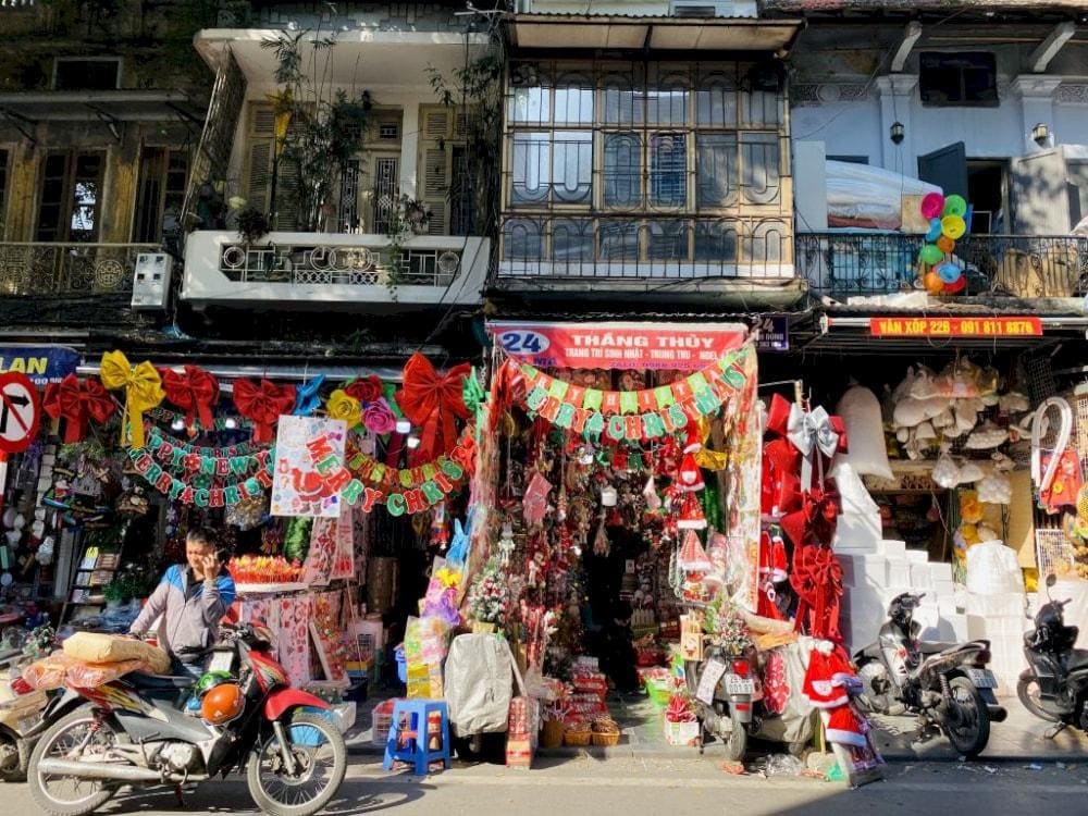 Cho Gioi Flea Market in Hanoi, featuring vendors selling electronics, motorbike parts, and rare collectibles